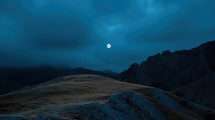 Wall Mural - Under a clear night sky, a full moon illuminates the rocky terrain, revealing the rugged contours of the mountains and valleys. The cool atmosphere evokes tranquility at dusk