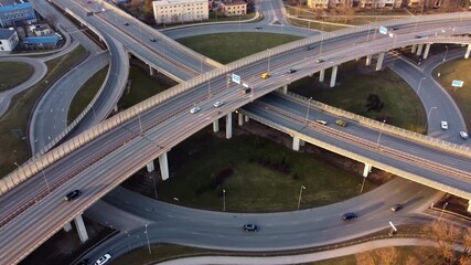 Wall Mural - Aerial static of cars across roundabout on ramp off ramp overpass in Riga, Latvia at dusk, Slavu rotary with moving traffic