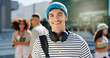© WestLey/peopleimages.com - Headphones, student and portrait of happy man in city for travel to university, college and school campus. Smile, relax and person with backpack in urban town for education, learning and knowledge