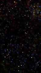 Wall Mural - colorful blurred dots flying on loop black vertical background.