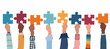 © melita - Problem solving concept. Raised hand up of multicultural business women and business men holding a jigsaw puzzle piece. Metaphor.Strategy concept.Joining puzzle pieces.Match.Isolated