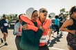 © Jacob Lund - Joyful friends running together showcasing age contrast in a marathon