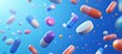 © artwiyanastudio - Colorful pills in motion against a vibrant blue background