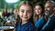© fotogurme - Young Caucasian girl smiling at a family gathering, joyful moments, festive outdoor celebration