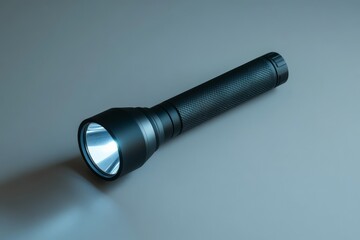 Poster - Bright LED flashlight resting on a smooth surface ready for nighttime adventures or emergency situations