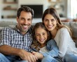 © mikail - A happy smiling family poses together on a sofa