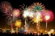 © Nico - Fourth of July Fireworks: Colorful fireworks lighting up the night sky over a cityscape, with a faint crowd watching from below