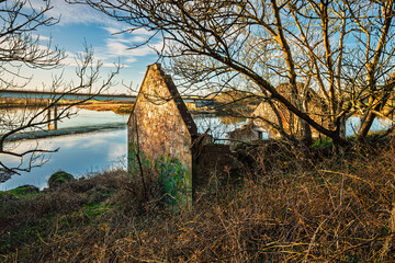 Wall Mural - derelict building beside river tweed road bridge. the river tweed is 97 miles long from source to es