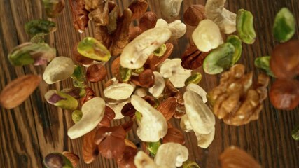 Poster - Super Slow Motion of Flying Nuts on Wooden Planks. Camera Tracking the Target. Filmed on High Speed Cinema Camera, 1000fps.