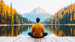 © Irina B - Tranquil reflection of a meditating man in nature amidst vibrant autumn foliage by serene mountain lake