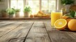 © leymart - Glass of orange juice on wooden table with oranges and kitchen background.