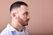© New Africa - Baldness problem. Man with receding hairline on dark beige background, space for text