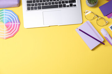 Wall Mural - designer's workplace. flat lay composition with stationery and laptop on yellow background, space fo