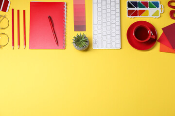 Wall Mural - designer's workplace. flat lay composition with stationery, keyboard and cup of coffee on yellow bac