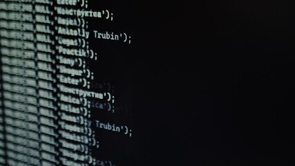 Blurry fast-moving lines of code appear on a screen, creating a futuristic Matrix-style effect, symbolizing hacking, data processing, or AI. A close-up shot of a computer screen.