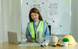 © Wanchai - A female engineer presenting a construction project to develop and plan the building of houses or apartments