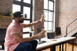 © Wavebreak Media - Man using VR headset in modern office, interacting with virtual environment, copy space