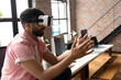 © Wavebreak Media - Man using VR headset in modern office, interacting with virtual environment, copy space