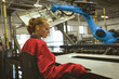 © Wavebreak Media - Female engineer operating machinery in modern factory, focused on precision work, copy space