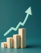 © Maryna - Rising arrow points up over wooden blocks graph steps on blue background. Investment, income, inflation, growth, success, business goal concepts. Growth diagram indicates marketing and sales progress.