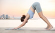 © JackF - Active woman take care of physical health and practice yoga, perform yoga exercise on beach at sunset outdoors