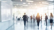 © Kafi - Blurred Business People Walking in Bright Modern Office Space