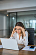 © insta_photos - Tired stressed mature business woman wearing glasses having headache at work feeling pain or burnout working on laptop computer in office. Worried fatigued businesswoman having stress at workplace.