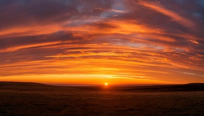 Wall Mural - wide panorama of a glowing orange striped sunset sky