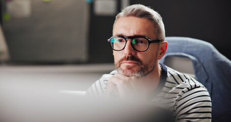 Fototapete - Browsing, night and man with computer, office and creative for web design with software or serious. Overtime, graphic designer and mature person with glasses in business, deadline or tech for project