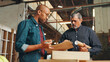 © peopleimages.com - Clipboard, teamwork or people in carpentry factory for manufacturing, inventory or furniture production. Woodworking, carpenter or project progress update for timber, lumber or construction business