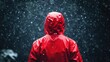 © SY - A person in a red hooded raincoat stands in the pouring rain. For articles, blogs and commercial use involving bad weather.