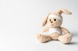 © BlueJay - Plush rabbit toy bandaged on head and body, sitting on white background, representing childhood injury, healthcare, or feeling unwell