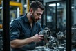 © RESTY - A man inspects a mechanical part in a workshop environment