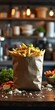 © BELLAMKONDA SOWJANYA - Crispy golden fries in a paper bag, garnished with parsley and salt
