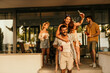 © La Famiglia - Friends enjoying drinks at a rooftop party, celebrating and having fun