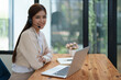 © Jirapong - Asian businesswoman wears a headset while participation in an online video conference discussing marketing and finance strategies effectively