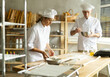 © caftor - Elderly man and woman kneading and whipping dough
