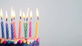 Decorative birthday candles placed on white background with copy space