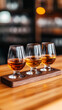 © Ruzana - Bourbon flight experience with tasting glasses on wooden board for beverage enthusiasts