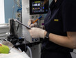 © Александр Лебедько - A veterinary anesthesiologist in gloves, writes in a tablet of vital pickers from monitors during an animal surgery in an operating veterinarian. Veterinary anesthetist during surgery on a pet.