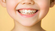 © Slamet - Closeup Child Smile With Healthy Teeth On Yellow Background