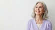 © Isolated Art - Happy Senior Woman, Smiling Mature Woman in Purple Cardigan - Studio Portrait, Positive Retirement Lifestyle