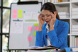 © Kainnika - Woman are stressed and have financial problems. Tired business woman sleepy and bored from sitting at a desk for a long time and has office syndrome.