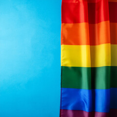 Wall Mural - lgbtq rainbow pride flag on blue background