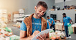 © peopleimages.com - Volunteer, writing and clipboard with man in warehouse for non profit, inventory checklist and donation project. Charity, social responsibility and food bank program with person in factory for ngo