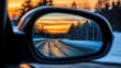© Nuttaya Nampai - A mesmerizing evening sky filled with sunset hues, seen perfectly in the car's side mirror.