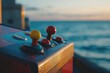 © jayantha - Retro arcade game control panel with joysticks, set against a calming ocean sunset.
