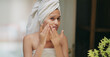 © Raushan_films - Indian upset young adult gen z woman lady wrapped towel on head and body look mirror feel sad facial pores skin dry cheek teen girl female worried for acne pimple touch face heath care at indoor home