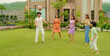 © Raushan_films - Indian happy family young man woman group play ball game throwing in air have fun joy enjoy outdoor park garden Playful cute teen girl son child kid boy with adult mom lady dad spend day time outside