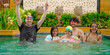 © Raushan_films - Indian happy family group with teen child look cam do funny pose enjoy outdoor resort pool trip Asian dad man male young adult girl boy female have fun joy spend day time at outside water park villa